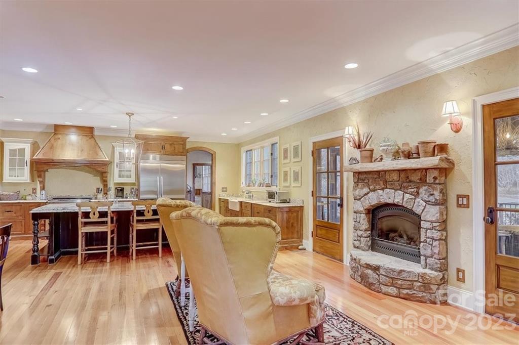 99 Mullally Drive Flat Rock, NC 28731 - Photo 10 of 48 a living room with furniture a fireplace a dining table and kitchen view