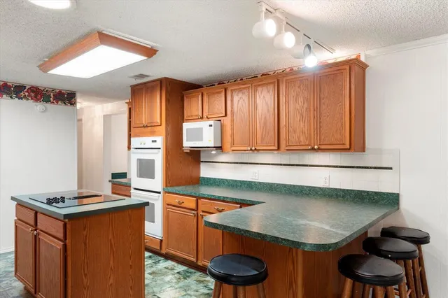 a kitchen with a sink cabinets and a window