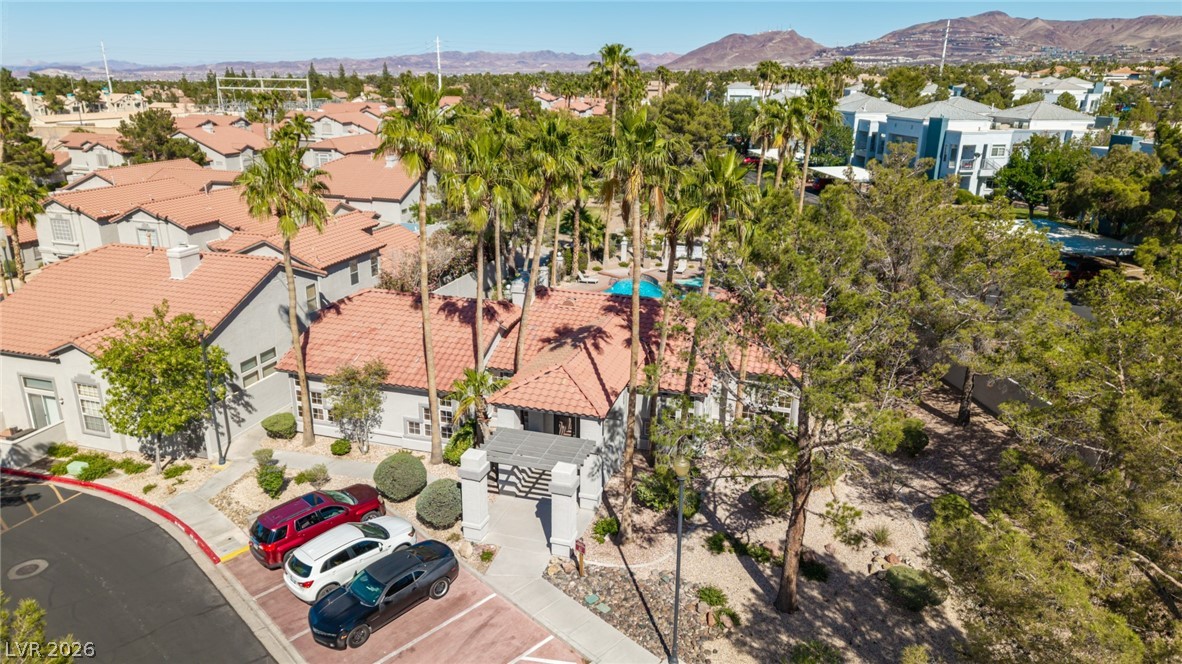 2223 Ramsgate Drive Henderson, NV 89074 - Photo 31 of 32 Lush landscaping and mature palm trees enhance this residential community's desert-inspired architecture.