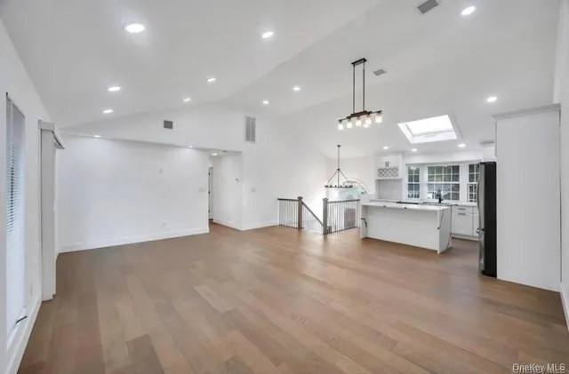 a view of kitchen with center island and stainless steel appliances