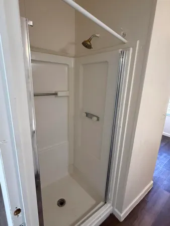 a bathroom with a glass door shower
