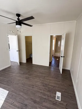 a view of a hallway with wooden floor