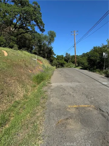a view of a road with a house in the background