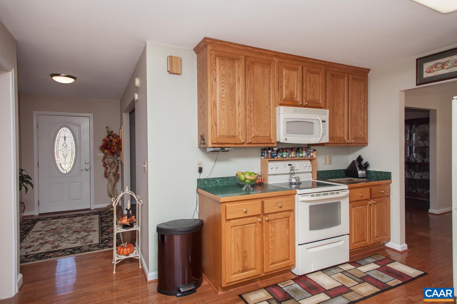 473 Reva Lane Ruckersville, VA 22968 - Photo 12 of 42 a kitchen with stainless steel appliances granite countertop a stove a sink dishwasher and cabinets with wooden floor