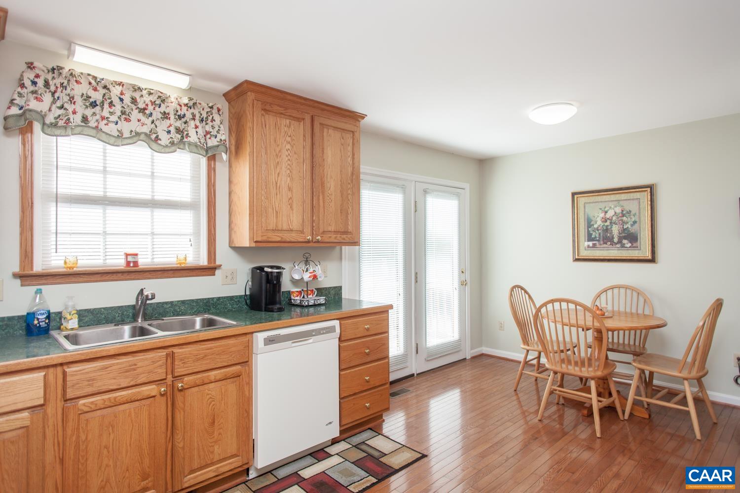 473 Reva Lane Ruckersville, VA 22968 - Photo 14 of 42 a kitchen with stainless steel appliances granite countertop a table chairs sink and cabinets