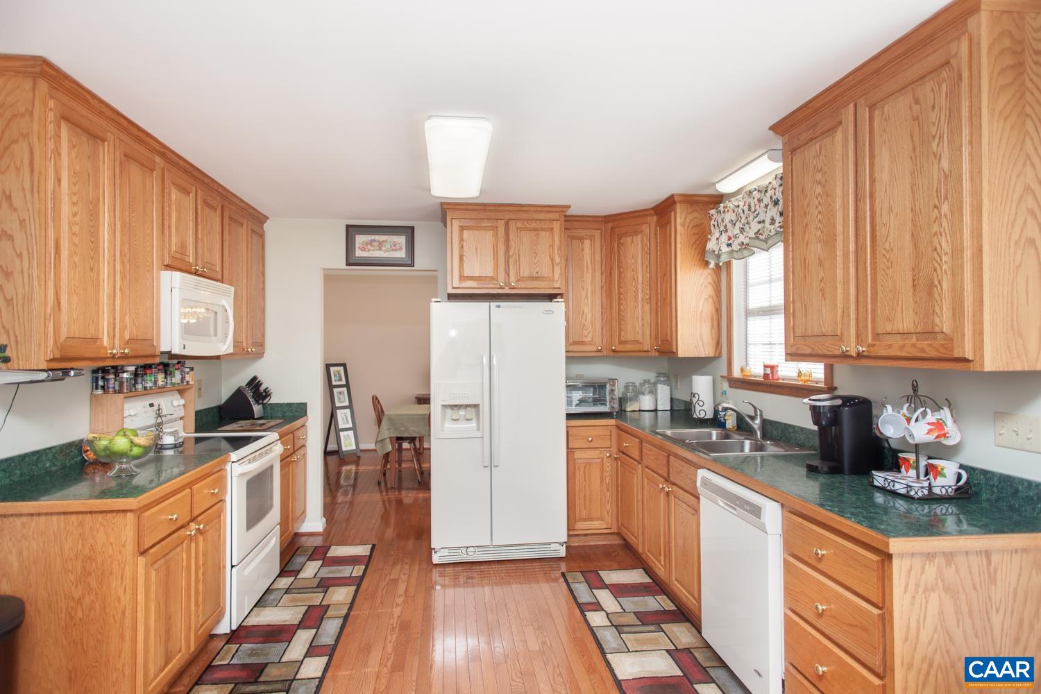 473 Reva Lane Ruckersville, VA 22968 - Photo 16 of 42 a kitchen with stainless steel appliances a refrigerator a sink and wooden cabinets