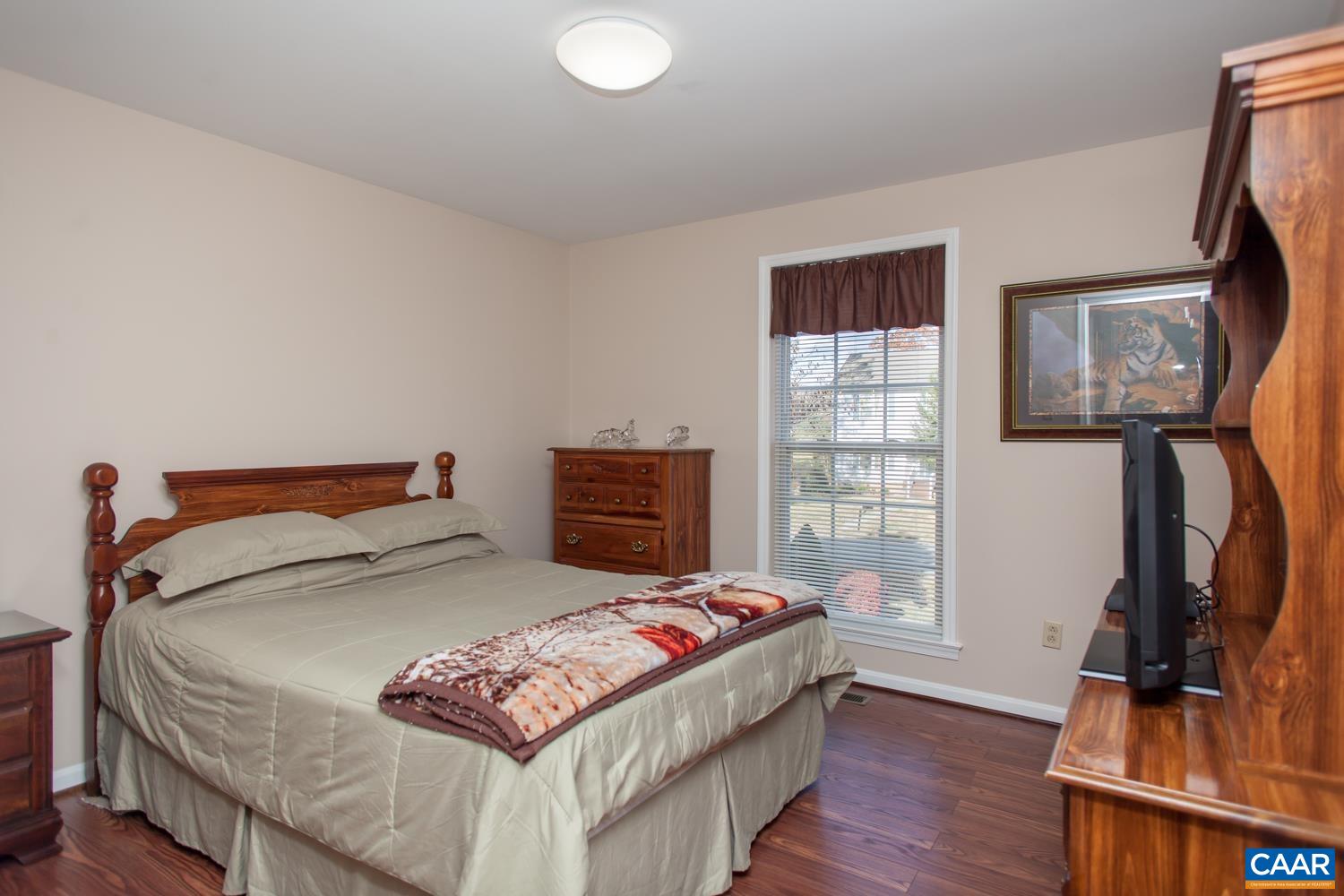 473 Reva Lane Ruckersville, VA 22968 - Photo 24 of 42 a bedroom with a bed and wooden floor