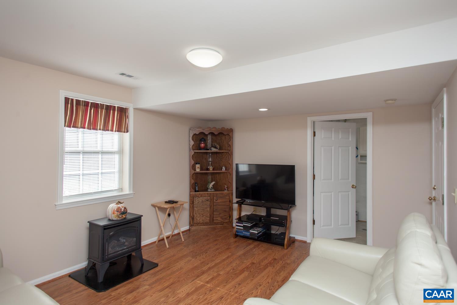 473 Reva Lane Ruckersville, VA 22968 - Photo 28 of 42 a living room with furniture and a flat screen tv