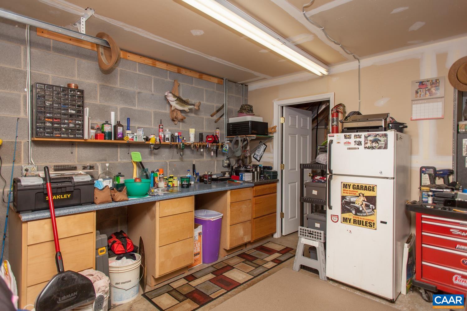 473 Reva Lane Ruckersville, VA 22968 - Photo 32 of 42 a kitchen with stainless steel appliances granite countertop a refrigerator and stove