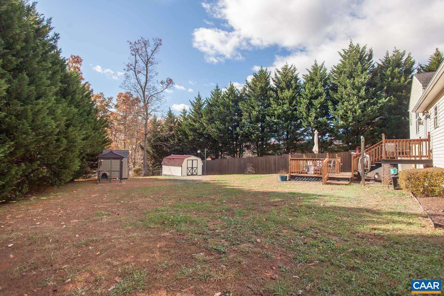 473 Reva Lane Ruckersville, VA 22968 - Photo 38 of 42 a view of a yard with table and chairs and a fire pit