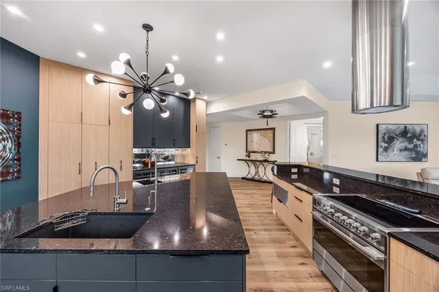 a kitchen with granite countertop a stove and a sink