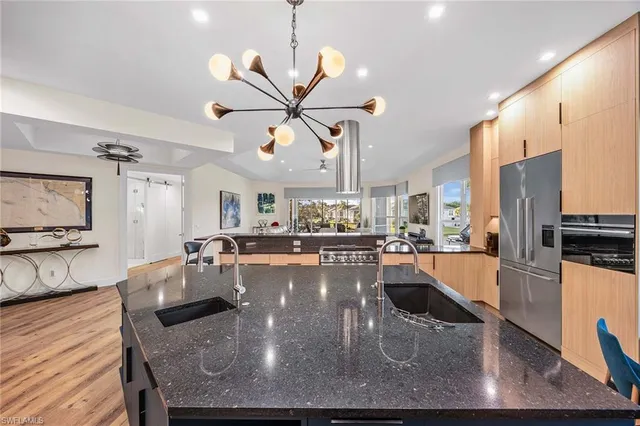 a large kitchen with a table and chairs