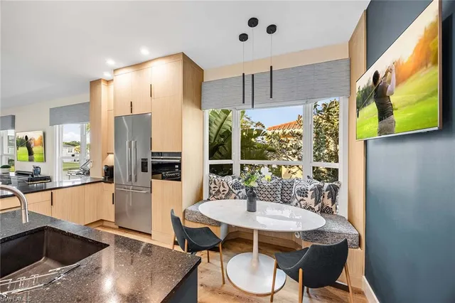 a view of a dining room with furniture and a potted plant