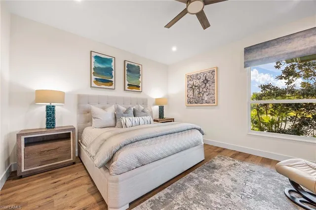 a spacious bedroom with a bed and a painting on the wall