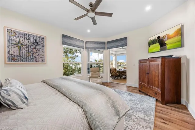 a spacious bedroom with a bed and a dresser