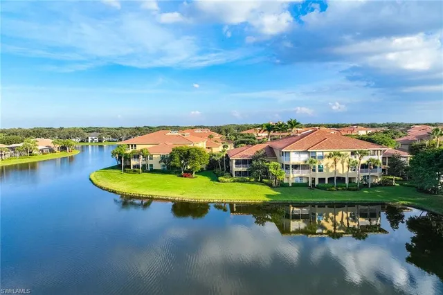 an aerial view of a house with a garden and lake view