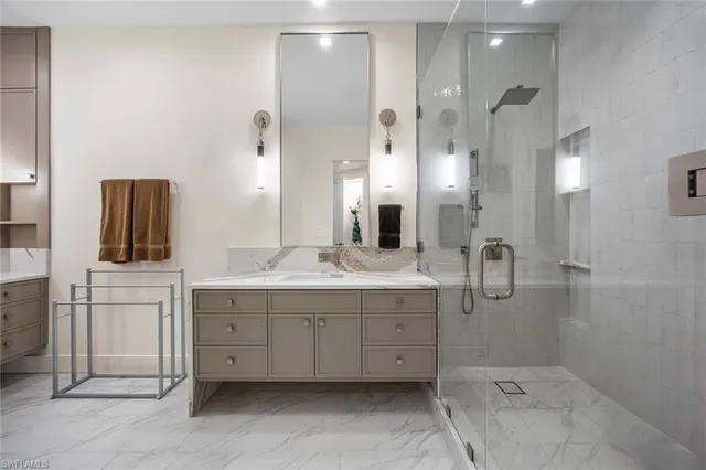 a bathroom with a double vanity sink mirror and shower