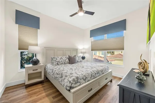 a bedroom with a bed and a flat tv screen on dresser