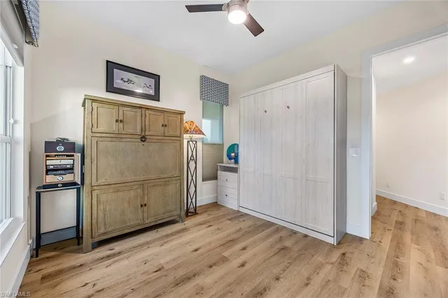 a kitchen with a refrigerator and a wooden floor
