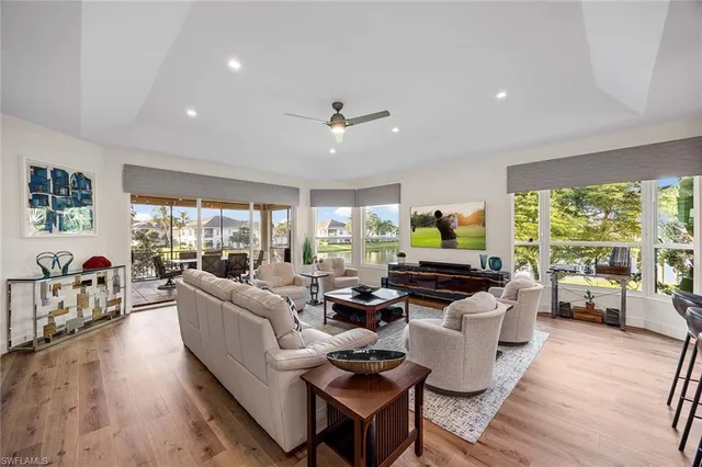 a living room with fireplace furniture and a large window