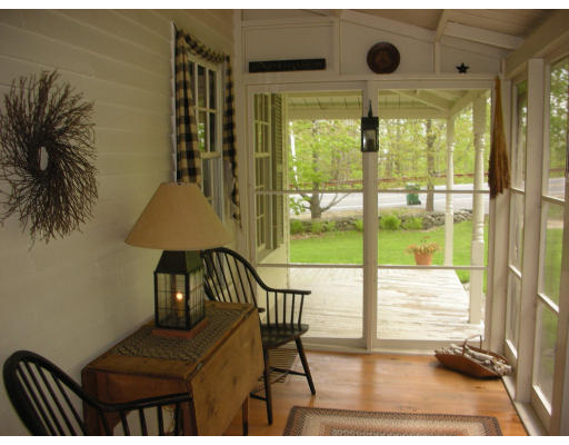 173 Mountain Road Princeton, MA 01541 - Photo 11 of 15 a view of a balcony with chair and wooden floor