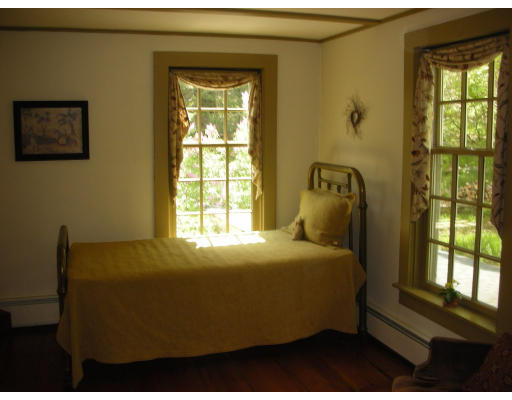 173 Mountain Road Princeton, MA 01541 - Photo 9 of 15 a bedroom with a bed and wooden floor