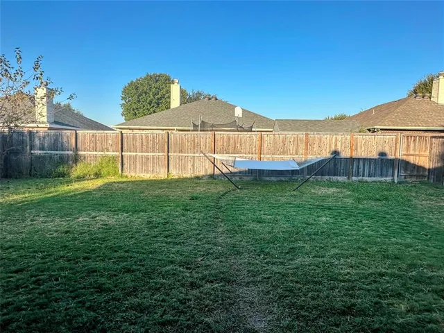 a backyard of a house with lots of green space and plants