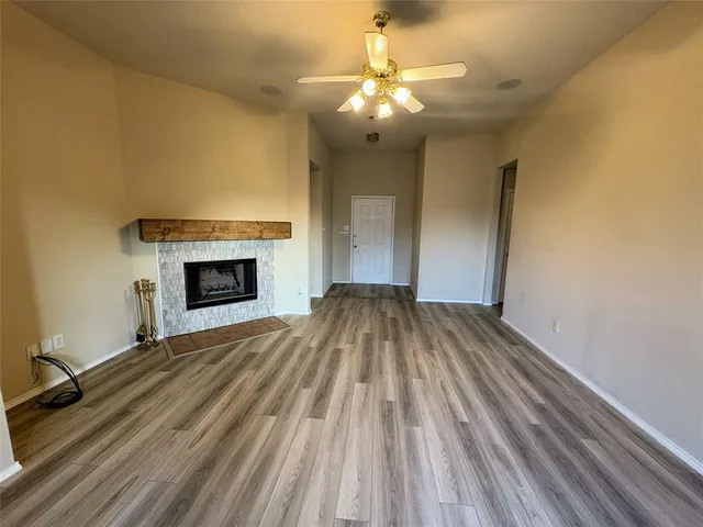 a view of empty room with a fireplace