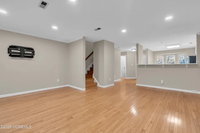 a view of a kitchen with a sink and a refrigerator