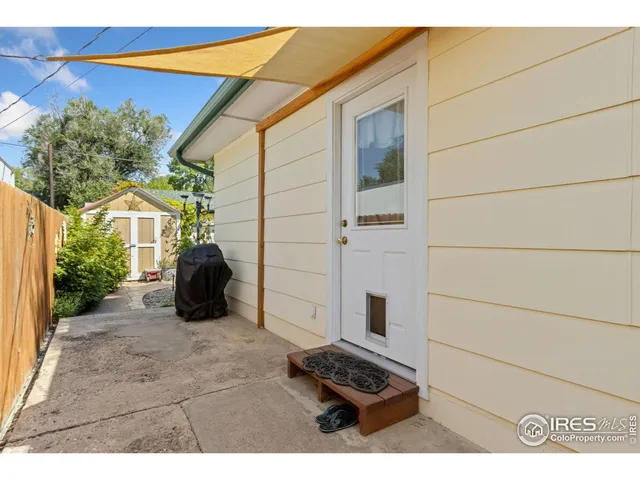 a view of a door and chair and table in the patio