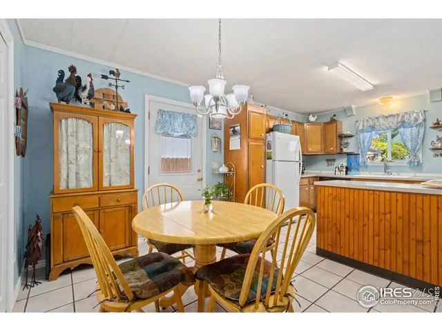 a dining room dining table chairs and a chandelier