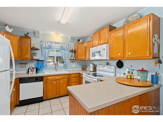 a kitchen with stainless steel appliances a sink a stove top oven a counter space and cabinets