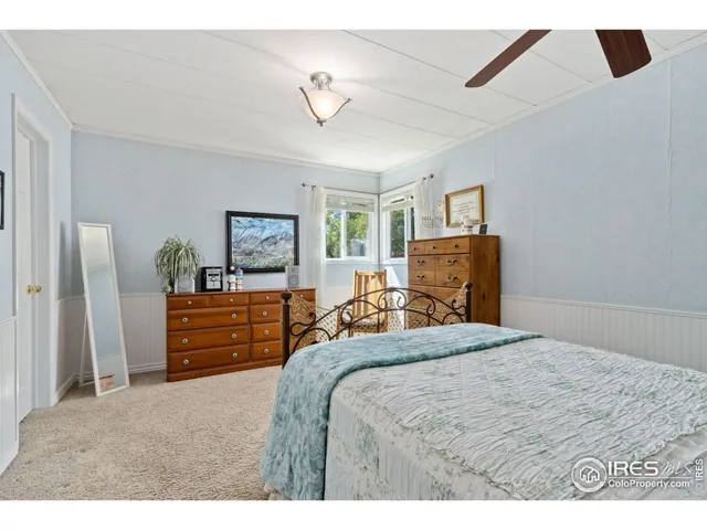 a bedroom with a bed and dresser with mirror