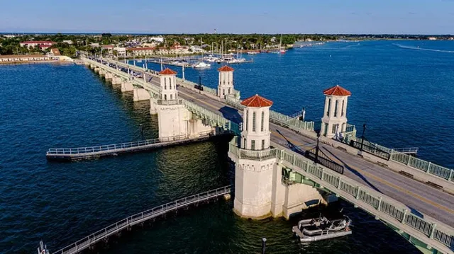 a view of a lake with lawn chairs