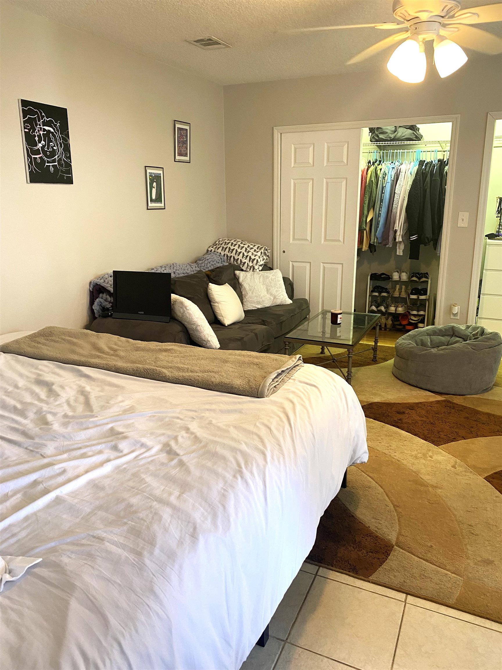 101 Flagler Boulevard, Unit D St. Augustine, FL 32080 - Photo 3 of 16 a spacious bedroom with double bed and a couch