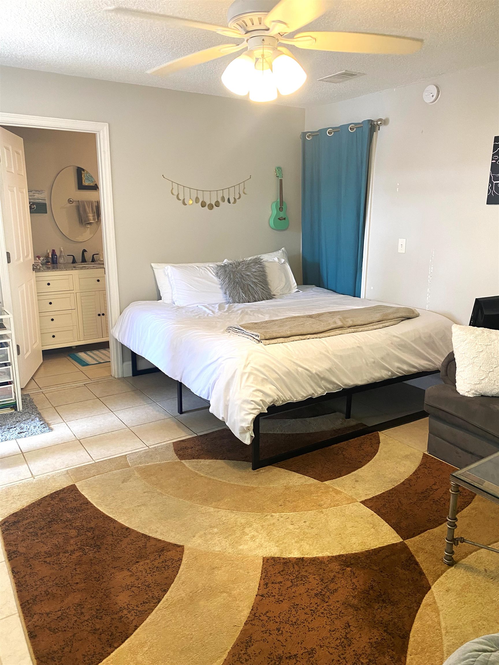 101 Flagler Boulevard, Unit D St. Augustine, FL 32080 - Photo 4 of 16 a bedroom with a bed and a mirror