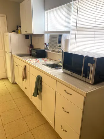 a kitchen with appliances a sink and a stove