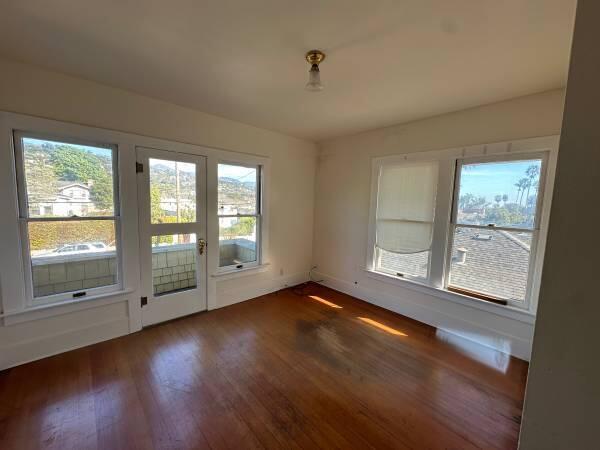 1629 Garden Street, Unit 1 Santa Barbara, CA 93101 - Photo 11 of 12 a view of an empty room with wooden floor and a window