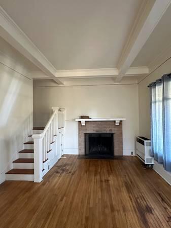 1629 Garden Street, Unit 1 Santa Barbara, CA 93101 - Photo 2 of 12 a view of a livingroom with wooden floor and a fireplace