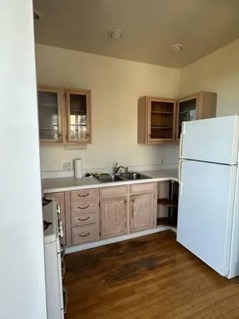a kitchen with sink refrigerator and microwave