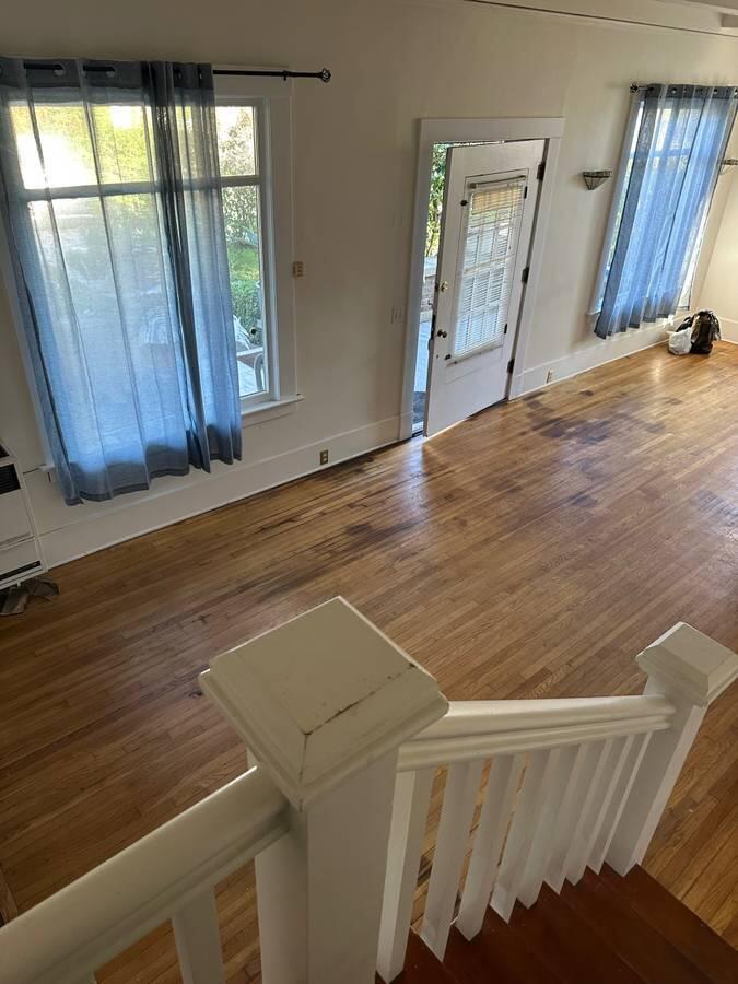 1629 Garden Street, Unit 1 Santa Barbara, CA 93101 - Photo 6 of 12 a view of an empty room with wooden floor and a window
