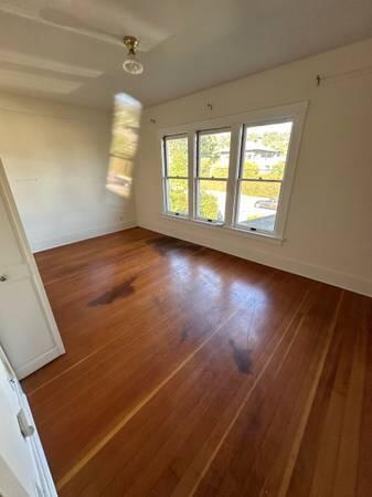 1629 Garden Street, Unit 1 Santa Barbara, CA 93101 - Photo 9 of 12 an empty room with wooden floor and windows