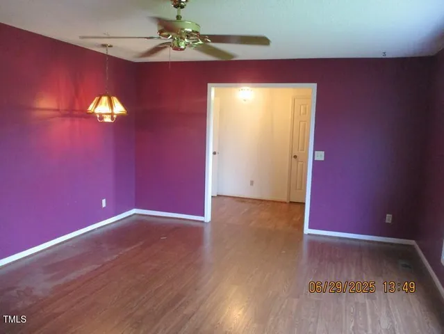 a view of a room with wooden floor and windows