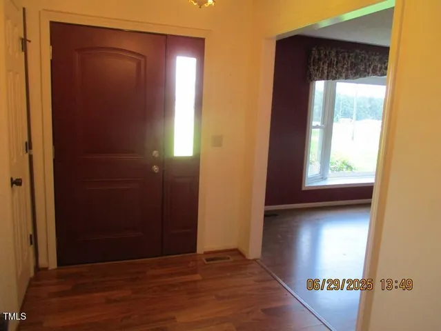 a view of entryway with wooden floor