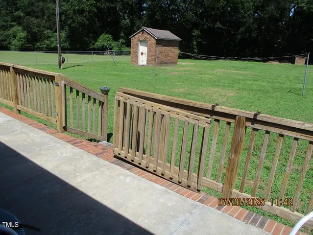 a view of a house with a yard and deck