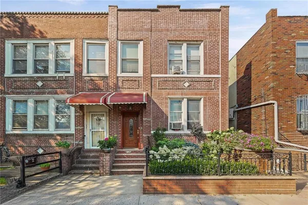 front view of a brick house with a large windows