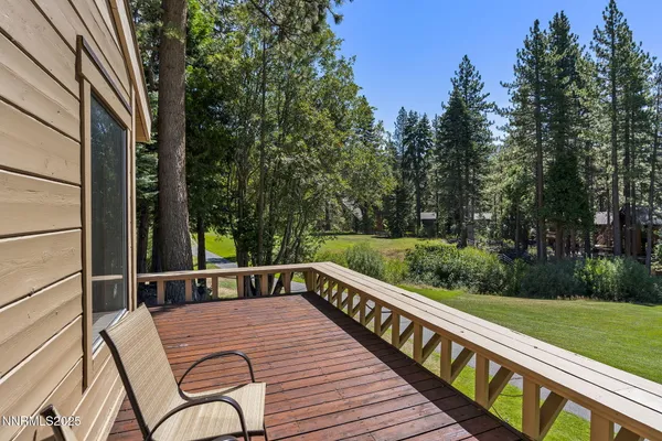 a view of balcony with wooden floor and outdoor seating
