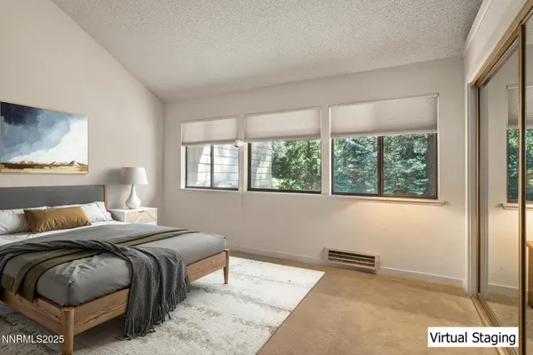 a bedroom with a bed lamp and window