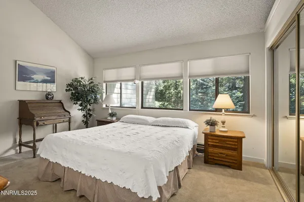 a bedroom with a bed and a potted plant