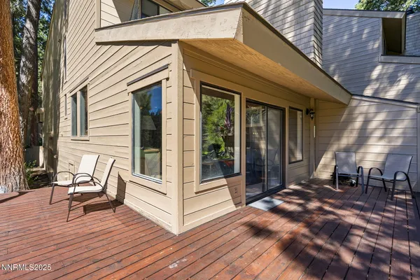 a view of patio with a table and chairs and wooden floor